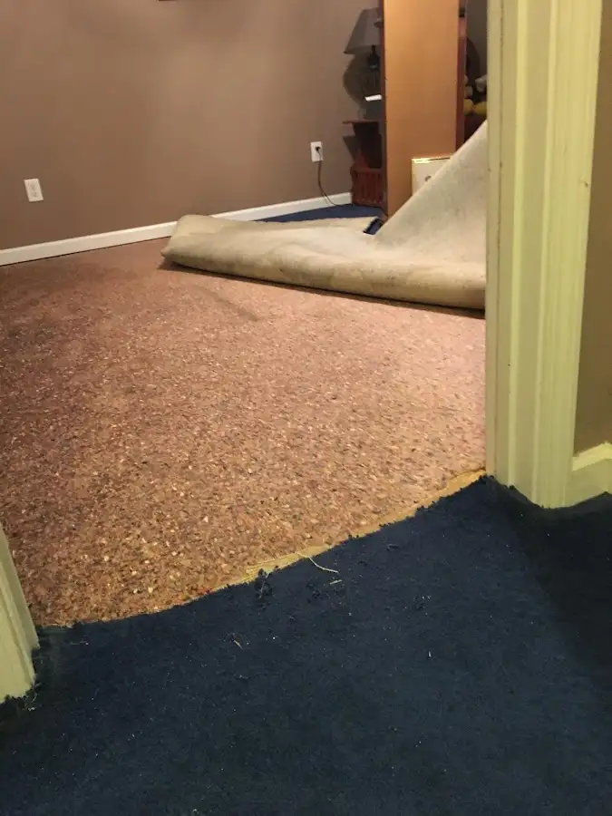 Carpet pad removal revealing water damage during Water Mitigation Services in Baldwin Park